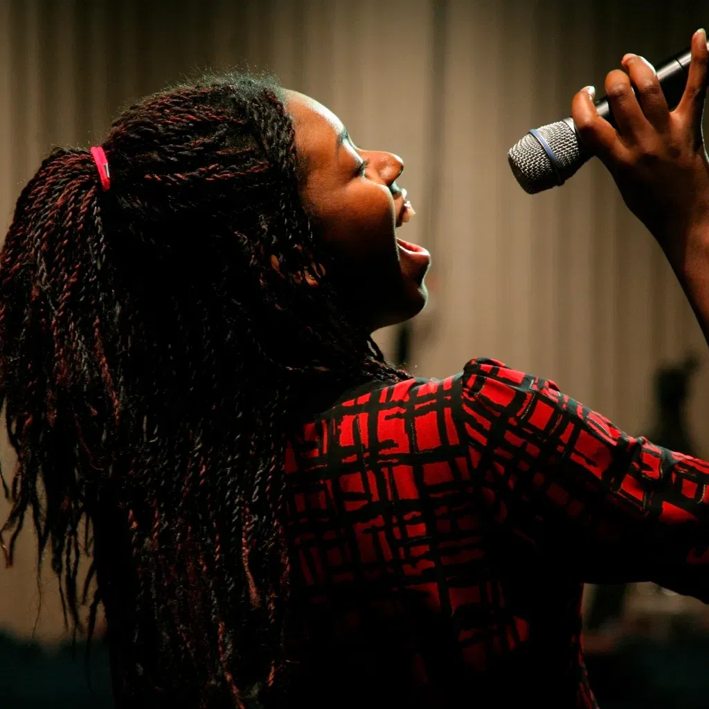 Student singing into a microphone
